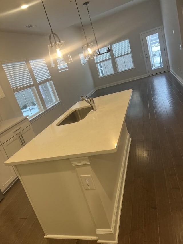 204 Douglas Bend Rd Unit 804, Gallatin, TN 37066 - kitchen featuring dark wood-type flooring, a center island with sink, light countertops, and white cabinets