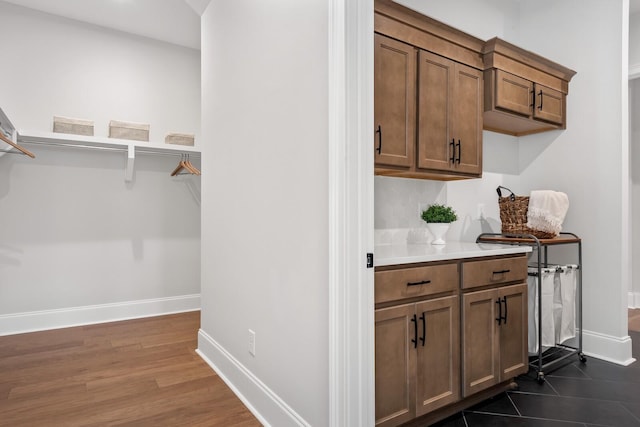 7262 Murrel Dr, Franklin, TN 37064 - bar area with baseboards and dark wood-type flooring