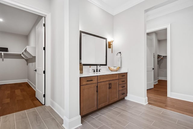 7262 Murrel Dr, Franklin, TN 37064 - bathroom featuring a spacious closet, wood finished floors, vanity, and crown molding