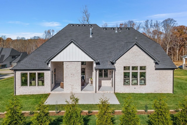 7262 Murrel Dr, Franklin, TN 37064 - back of property with brick siding, a patio area, board and batten siding, a shingled roof, and a lawn