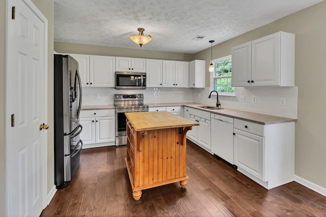 3133 Winberry Dr, Franklin, TN 37064 - kitchen with stainless steel appliances, butcher block countertops, white cabinets, backsplash, and a textured ceiling