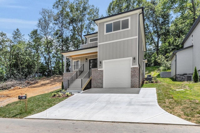 333 Isbill Rd, Chattanooga, TN 37419 - contemporary home with brick siding, stairway, driveway, a front yard, and a garage