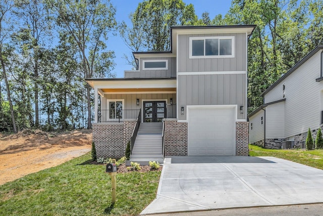 333 Isbill Rd, Chattanooga, TN 37419 - contemporary home with covered porch, board and batten siding, stairs, driveway, and brick siding