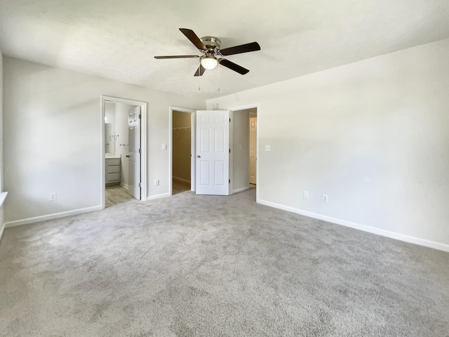 7203 Chester Rd, Fairview, TN 37062 - unfurnished bedroom featuring a walk in closet, carpet floors, a closet, connected bathroom, and a ceiling fan