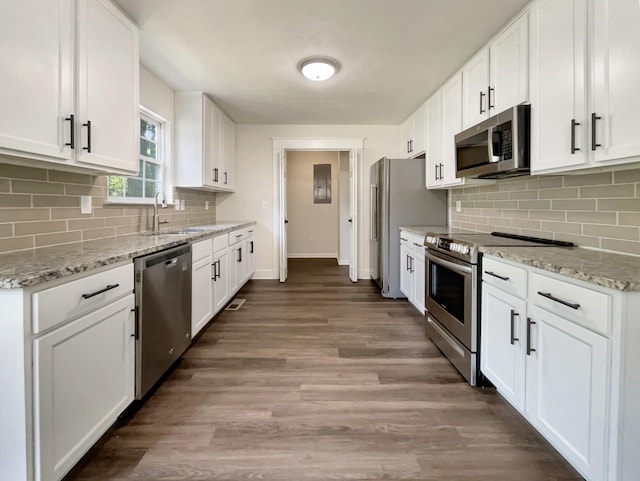 7203 Chester Rd, Fairview, TN 37062 - kitchen featuring stainless steel appliances, white cabinets, wood finished floors, and backsplash