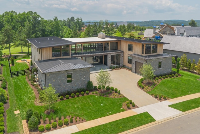 8005 Backwoods Dr, College Grove, TN 37046 - view of front of house featuring driveway, an attached garage, a chimney, and stone siding