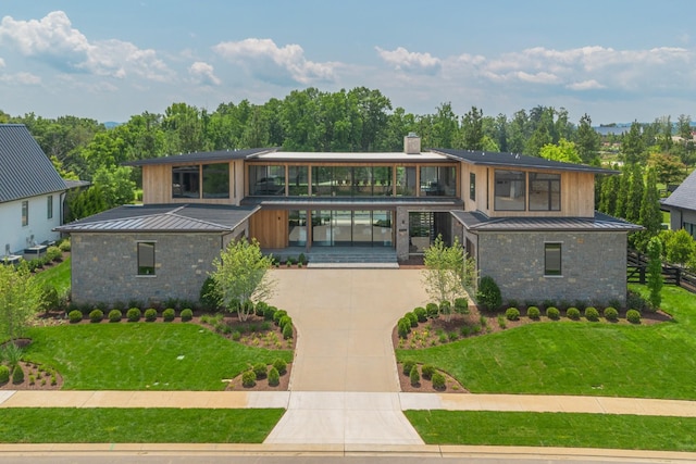 8005 Backwoods Dr, College Grove, TN 37046 - contemporary home with a standing seam roof, a chimney, a metal roof, a front lawn, and concrete driveway