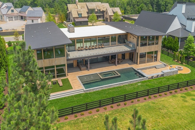 8005 Backwoods Dr, College Grove, TN 37046 - back of property featuring a sunroom, a pool with connected hot tub, a residential view, a fire pit, and a patio area