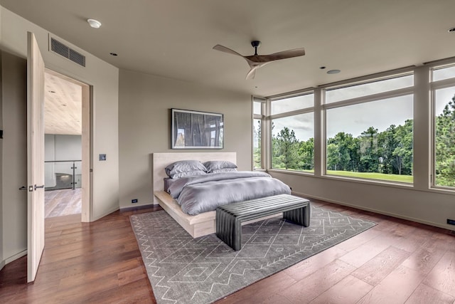 8005 Backwoods Dr, College Grove, TN 37046 - bedroom with multiple windows, wood finished floors, and a ceiling fan