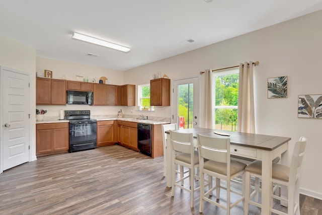 5 Oak Ridge Ct NE, Rome, GA 30165 - kitchen featuring black appliances, brown cabinetry, and light countertops
