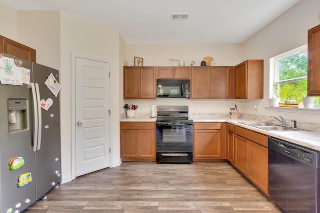 5 Oak Ridge Ct NE, Rome, GA 30165 - kitchen with black appliances, light wood-style floors, light countertops, and brown cabinetry
