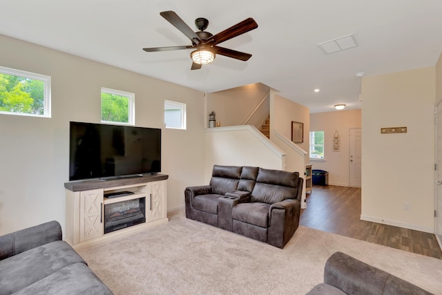 5 Oak Ridge Ct NE, Rome, GA 30165 - carpeted living area with ceiling fan, stairway, a glass covered fireplace, and wood finished floors