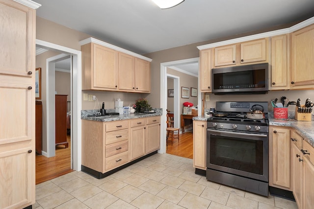 3502 Kellys Ferry Rd, Chattanooga, TN 37419 - kitchen featuring appliances with stainless steel finishes, light brown cabinetry, light tile patterned floors, crown molding, and light stone counters