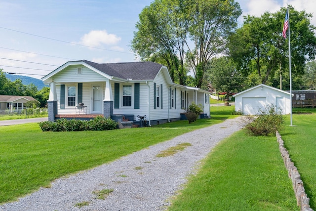3502 Kellys Ferry Rd, Chattanooga, TN 37419 - view of front of house with a porch, an outbuilding, a front lawn, driveway, and a detached garage