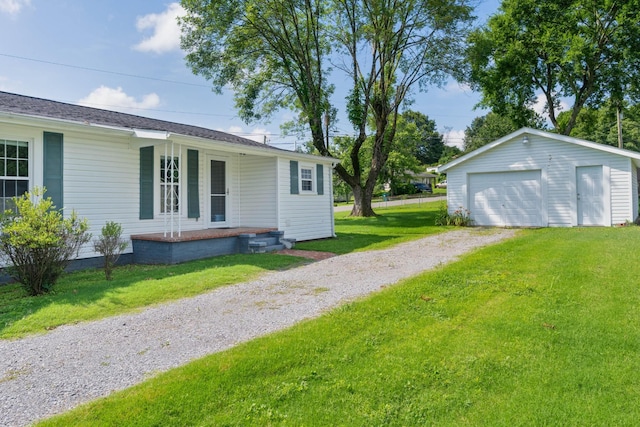 3502 Kellys Ferry Rd, Chattanooga, TN 37419 - view of green lawn featuring driveway, a garage, an outbuilding, and covered porch