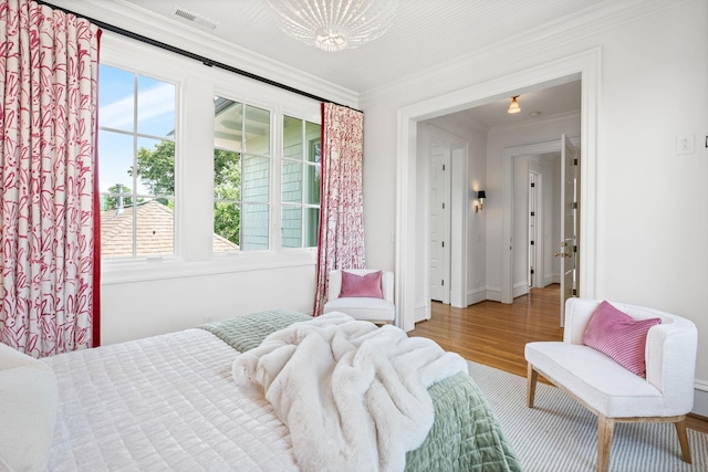 1504 Sweetbriar Ave, Nashville, TN 37212 - bedroom featuring multiple windows, ornamental molding, and wood finished floors