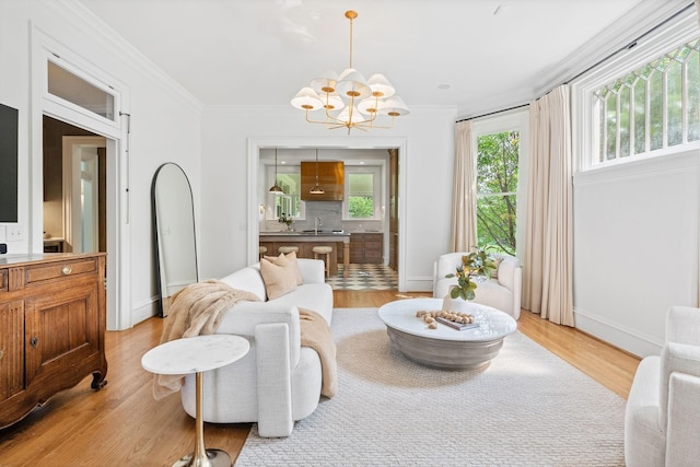 1504 Sweetbriar Ave, Nashville, TN 37212 - living room featuring a chandelier, ornamental molding, and light wood-style floors