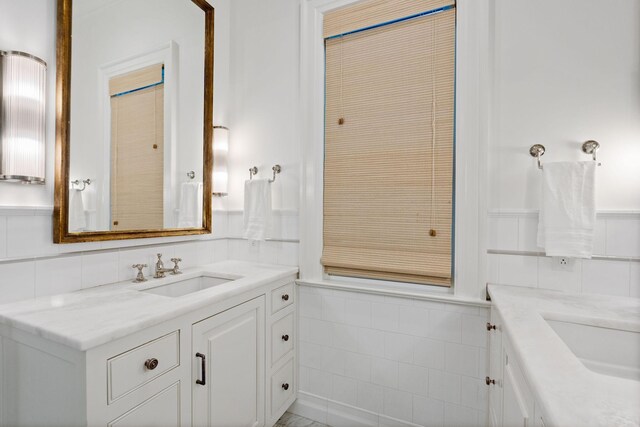 1504 Sweetbriar Ave, Nashville, TN 37212 - bathroom featuring tile walls, vanity, and a wainscoted wall
