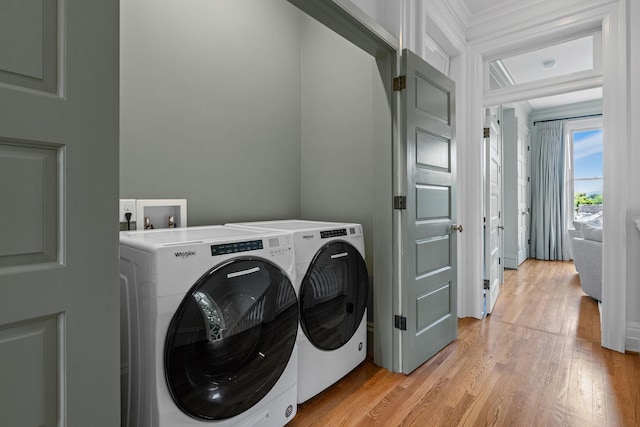 1504 Sweetbriar Ave, Nashville, TN 37212 - laundry area featuring light wood-type flooring, separate washer and dryer, and ornamental molding