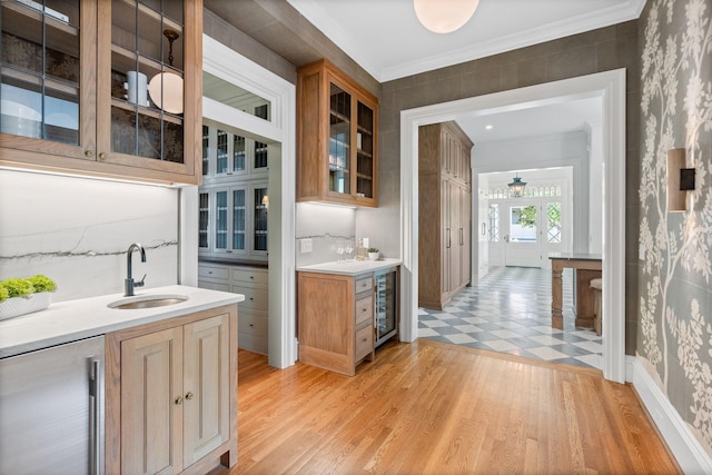 1504 Sweetbriar Ave, Nashville, TN 37212 - bar area featuring wine cooler, wallpapered walls, ornamental molding, and light wood finished floors