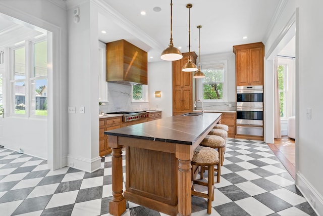 1504 Sweetbriar Ave, Nashville, TN 37212 - kitchen with appliances with stainless steel finishes, backsplash, brown cabinets, crown molding, and a breakfast bar