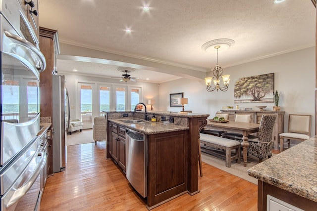 55B Oasis Ln, Savannah, TN 38372 - kitchen with appliances with stainless steel finishes, ornamental molding, light wood-type flooring, a chandelier, and a ceiling fan