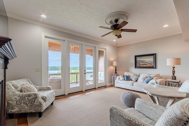55B Oasis Ln, Savannah, TN 38372 - living room with wood finished floors, a ceiling fan, a water view, recessed lighting, and ornamental molding