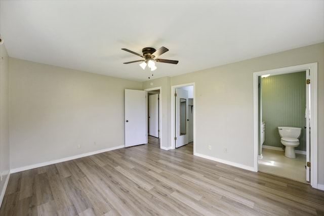 17930 Main St W, Huntingdon, TN 38344 - unfurnished bedroom featuring light wood-style flooring, ensuite bathroom, a walk in closet, and a ceiling fan