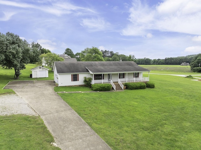 17930 Main St W, Huntingdon, TN 38344 - view of front of home with covered porch, an outbuilding, driveway, and a front lawn