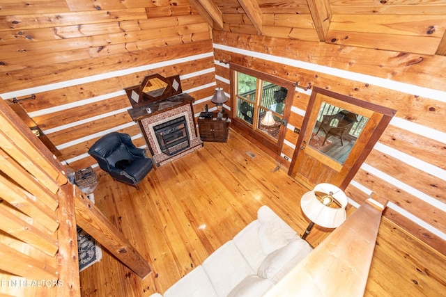 311 Domar Dr, Townsend, TN 37882 - living room featuring wood walls, a glass covered fireplace, light wood finished floors, and a wooden ceiling with exposed beams