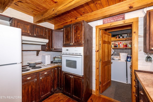311 Domar Dr, Townsend, TN 37882 - kitchen with white appliances, under cabinet range hood, a wood ceiling with exposed beams, washer and clothes dryer, and dark wood finished floors