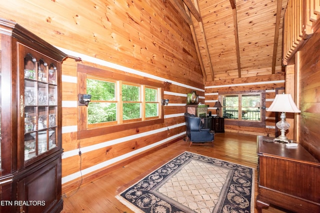 311 Domar Dr, Townsend, TN 37882 - living area featuring wood ceiling, wood walls, vaulted ceiling, healthy amount of natural light, and hardwood / wood-style flooring