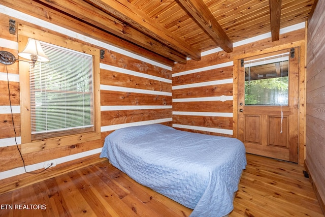 311 Domar Dr, Townsend, TN 37882 - bedroom with wooden walls, a wooden ceiling with exposed beams, and hardwood / wood-style flooring