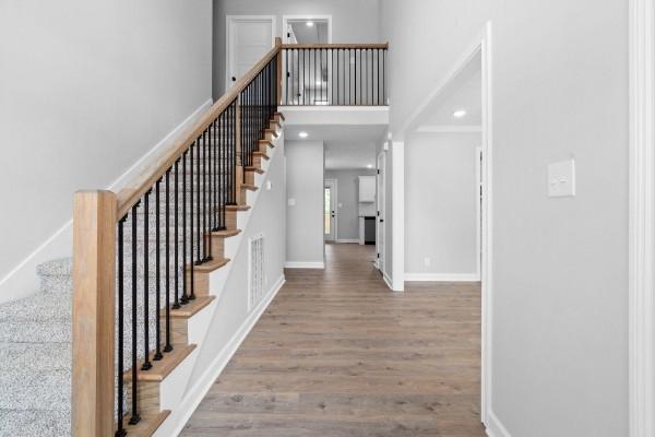 122 Monaghan Dr, Clarksville, TN 37042 - staircase with wood finished floors, a towering ceiling, and recessed lighting