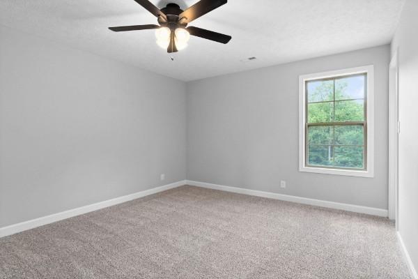122 Monaghan Dr, Clarksville, TN 37042 - carpeted spare room with baseboards and a ceiling fan
