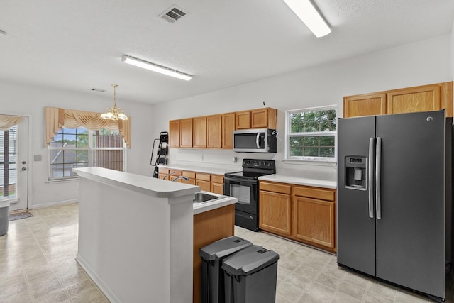219 Wyndom Ct, Goodlettsville, TN 37072 - kitchen featuring stainless steel appliances, a chandelier, light countertops, a center island, and decorative light fixtures