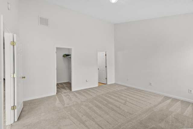 219 Wyndom Ct, Goodlettsville, TN 37072 - unfurnished bedroom featuring light colored carpet, a walk in closet, a towering ceiling, and a closet
