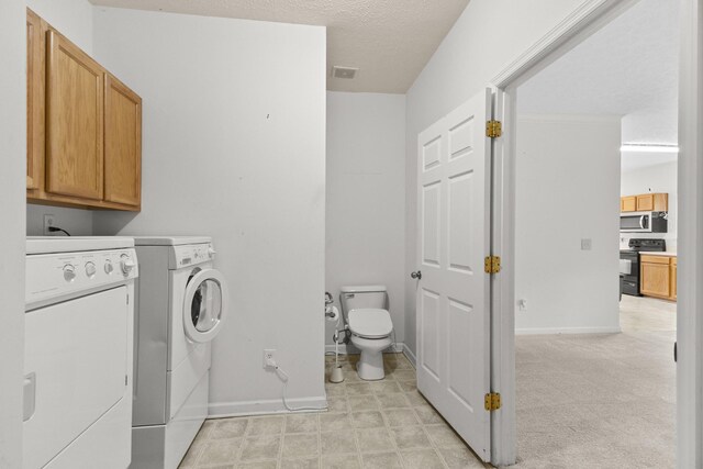 219 Wyndom Ct, Goodlettsville, TN 37072 - laundry room featuring washing machine and dryer and a textured ceiling