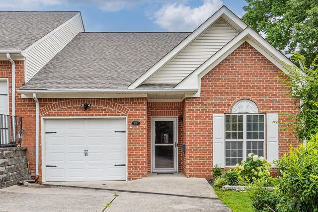 219 Wyndom Ct, Goodlettsville, TN 37072 - view of front of home featuring a shingled roof, brick siding, a garage, and driveway