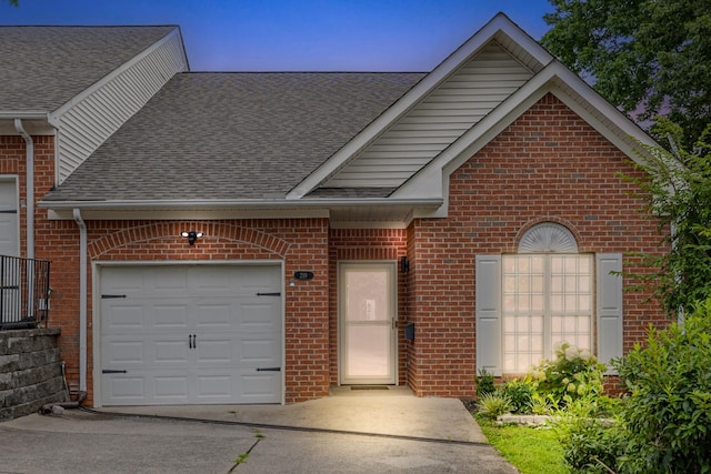219 Wyndom Ct, Goodlettsville, TN 37072 - traditional-style home featuring roof with shingles, brick siding, a garage, and concrete driveway