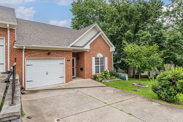 219 Wyndom Ct, Goodlettsville, TN 37072 - traditional-style home with roof with shingles, a garage, concrete driveway, brick siding, and a front yard