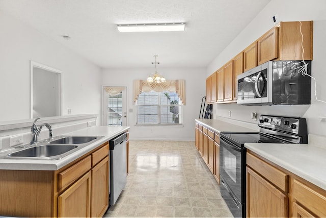 219 Wyndom Ct, Goodlettsville, TN 37072 - kitchen with stainless steel appliances, light countertops, pendant lighting, and a chandelier