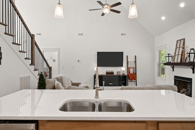 4049 Sadie Grace Way NW, Clarksville, TN 37042 - kitchen featuring open floor plan, high vaulted ceiling, ceiling fan, hanging light fixtures, and a fireplace