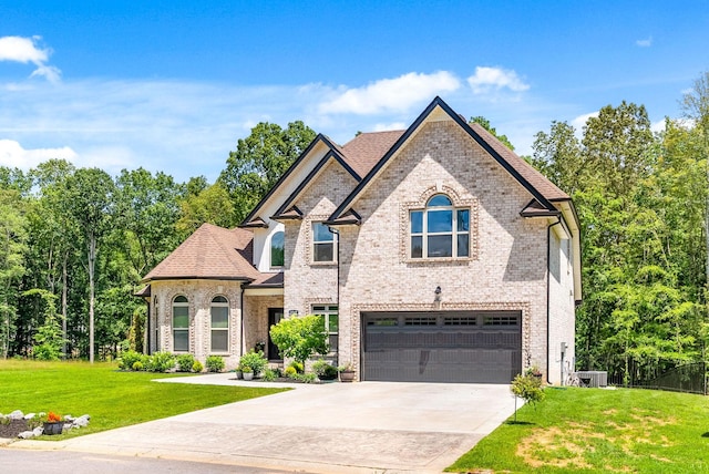 4049 Sadie Grace Way NW, Clarksville, TN 37042 - french country style house featuring a garage, a front lawn, driveway, and brick siding