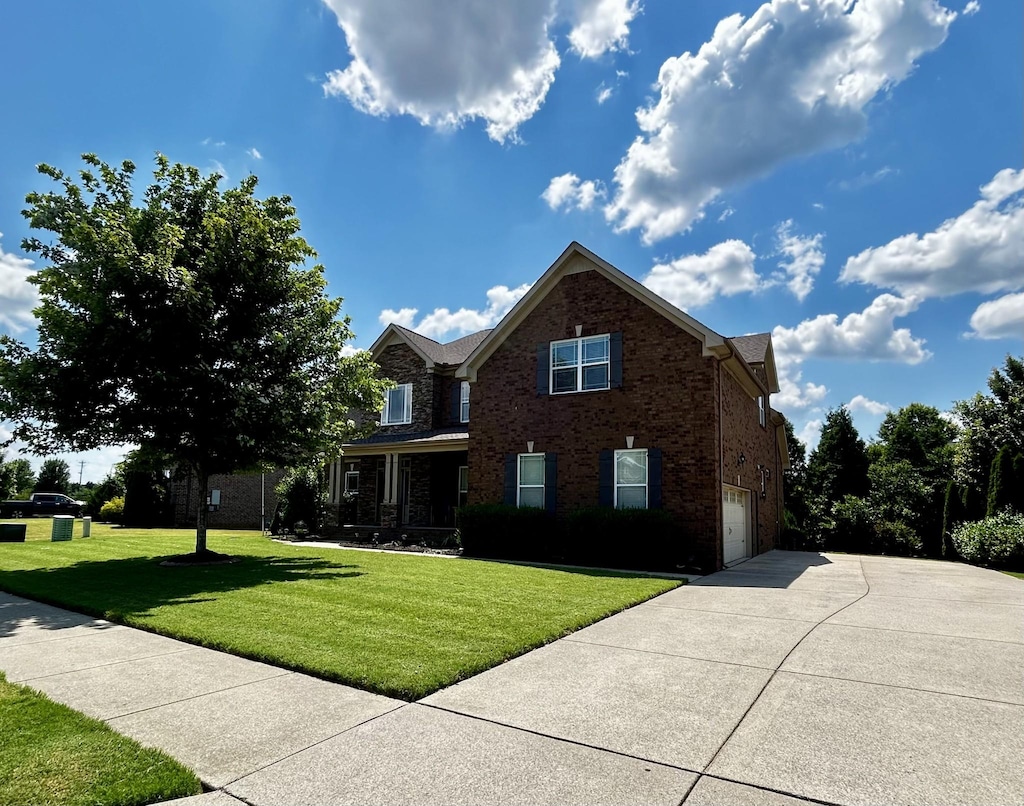 1007 Via Francesco Way, Spring Hill, TN 37174 - view of front of house with a garage, concrete driveway, brick siding, and a front yard