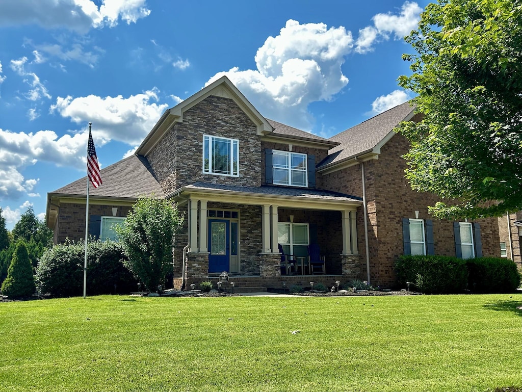 1007 Via Francesco Way, Spring Hill, TN 37174 - view of front of house with covered porch, a front lawn, brick siding, and a shingled roof