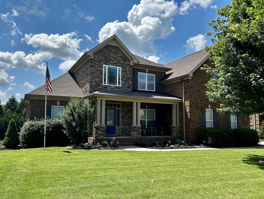 1007 Via Francesco Way, Spring Hill, TN 37174 - craftsman house with a front yard, a porch, brick siding, and roof with shingles