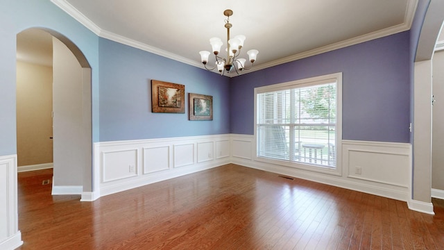 1007 Via Francesco Way, Spring Hill, TN 37174 - empty room with arched walkways, wood finished floors, ornamental molding, a chandelier, and a wainscoted wall