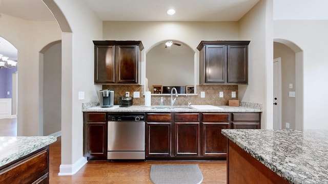 1007 Via Francesco Way, Spring Hill, TN 37174 - kitchen with stainless steel dishwasher, tasteful backsplash, light wood-style floors, light stone countertops, and recessed lighting