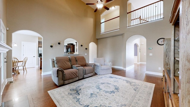 1007 Via Francesco Way, Spring Hill, TN 37174 - living room with arched walkways, ceiling fan, a towering ceiling, and wood finished floors